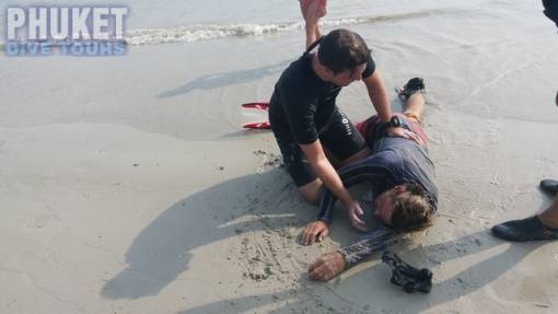 Rescue diver places the victim into the recovery position