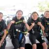 open water course students learning to dive on a Boat