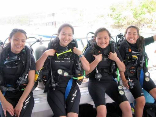 open water course students learning to dive on a Boat